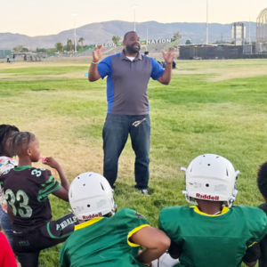 Getro speaking to little league football children