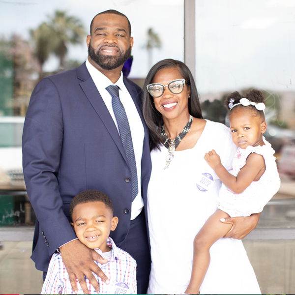 Getro Elize posing with wife, daughter and son smiling